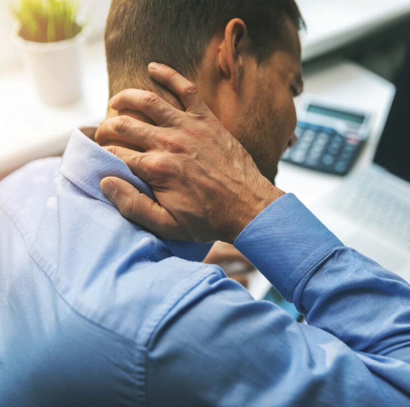 man holding his neck in pain