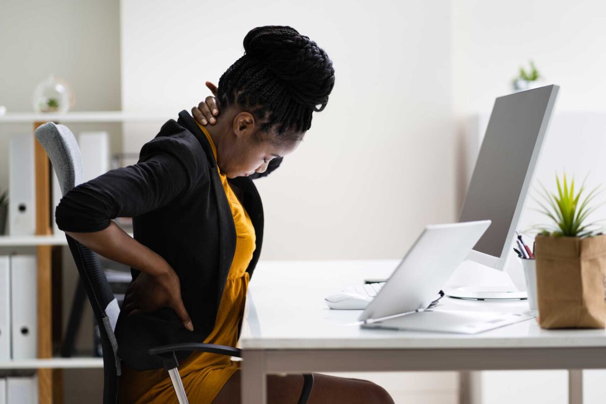 woman at desk with neck and back pain