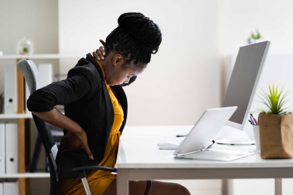 woman at desk with neck and back pain
